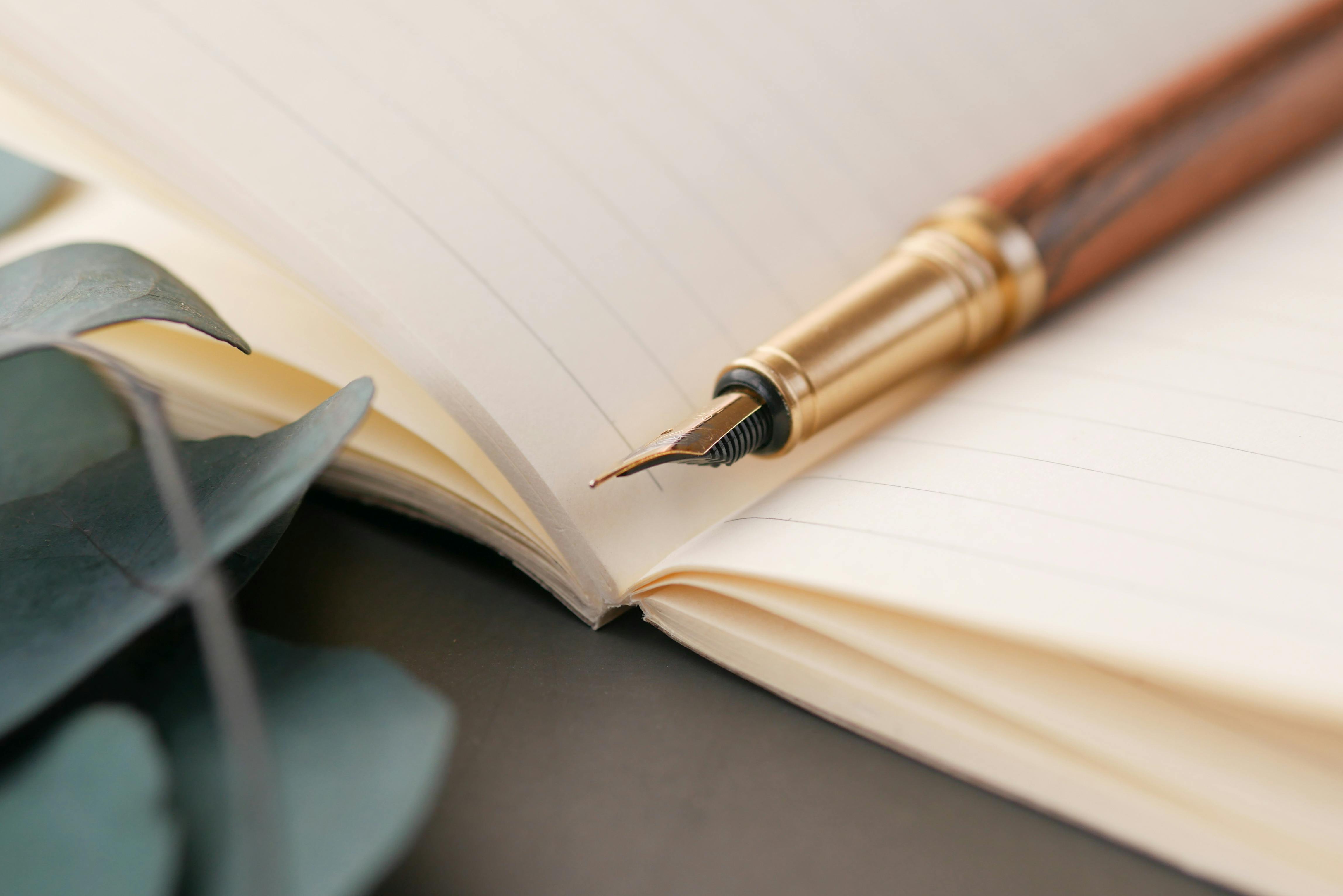 Fountain pen resting on a notebook for estates, wills, and administration