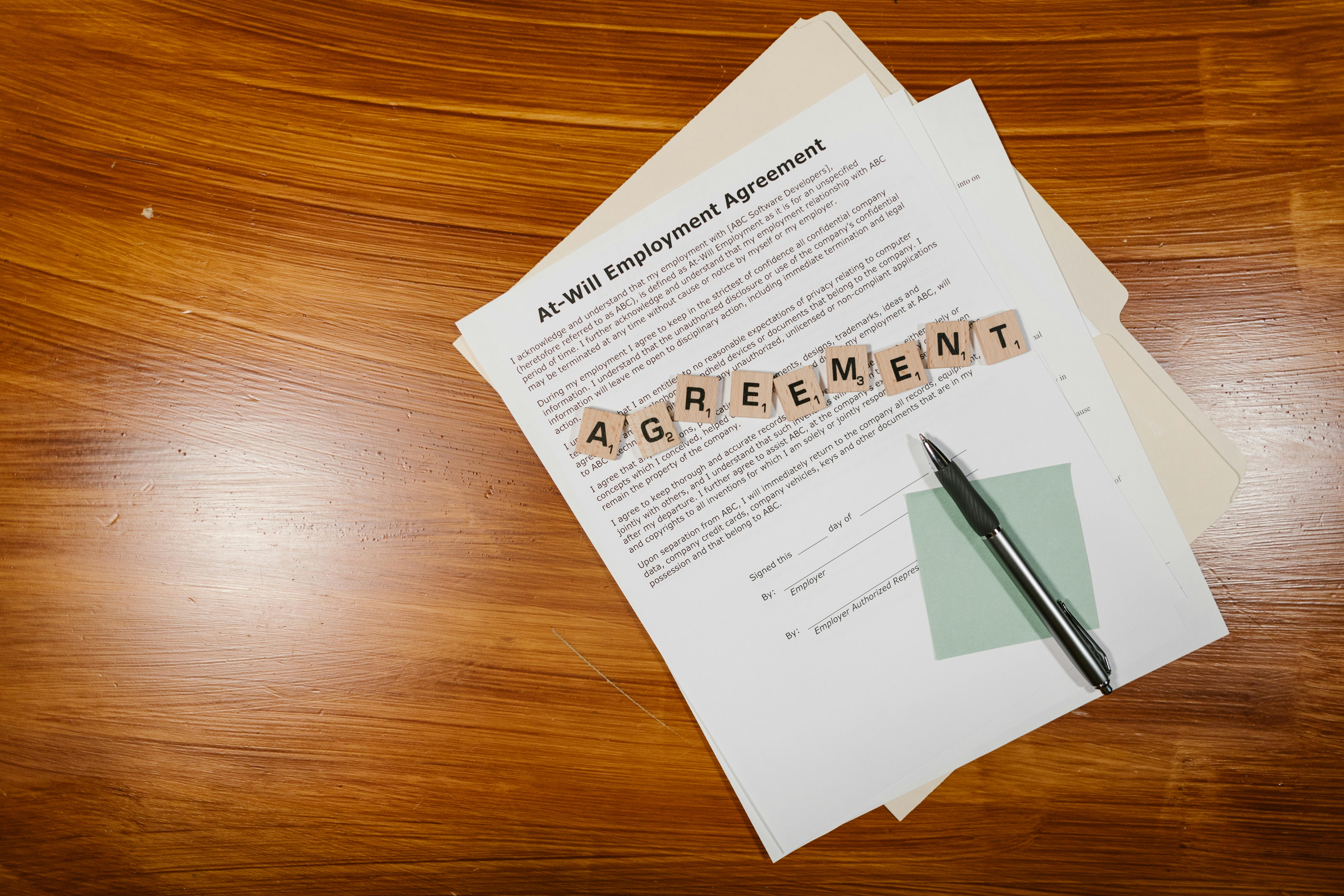 Employment agreement documents arranged on a desk